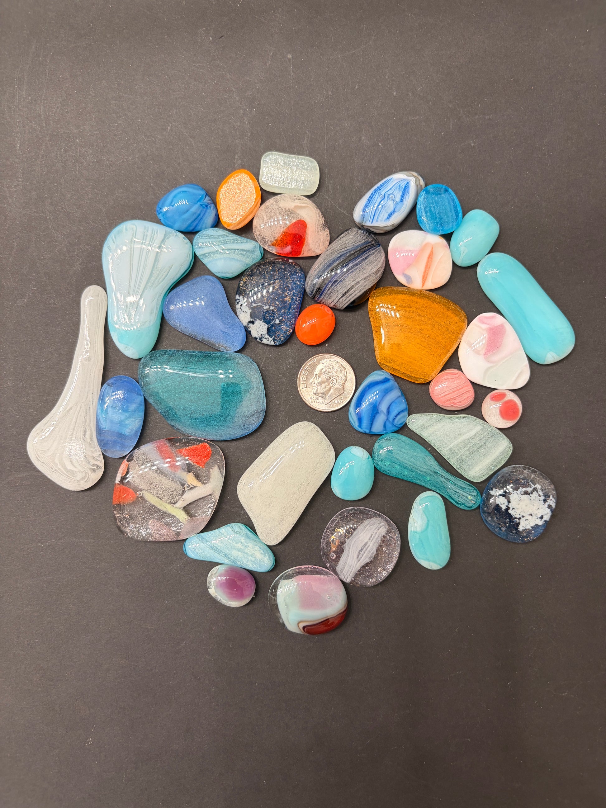 Glow grab bags full of glass blobs in various shapes, sizes and glow colours.